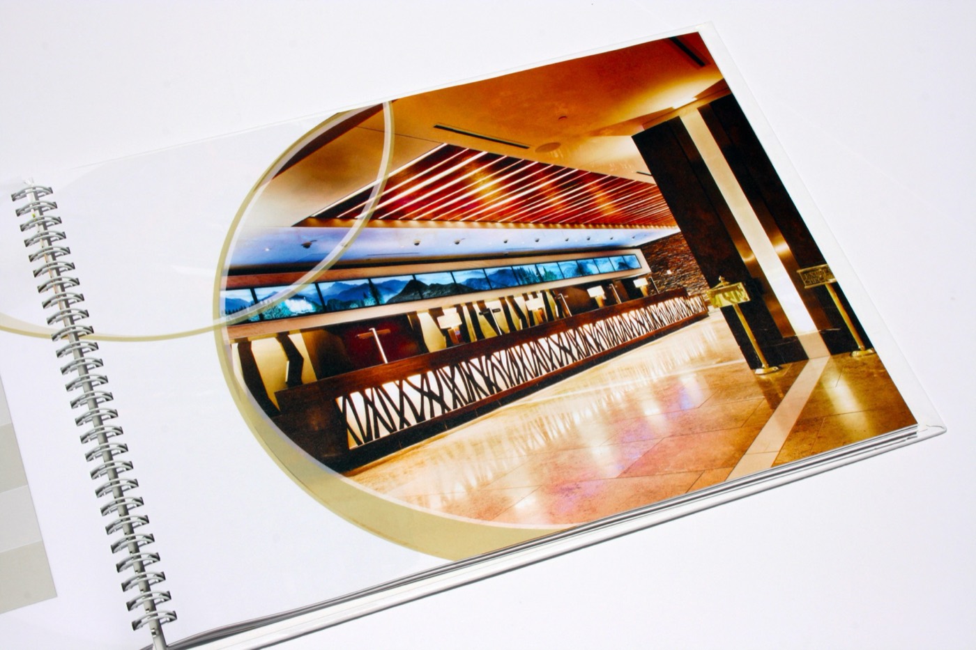 A spiral-bound book open to interior photography