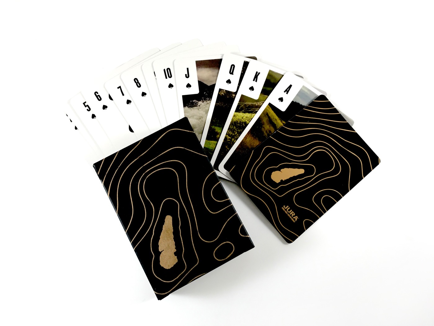 A fanned deck of black playing cards with gold detail