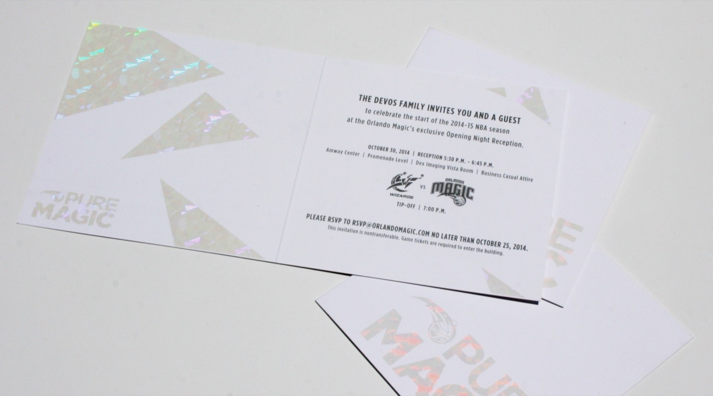 A flat printed invitation with holographic foil corners